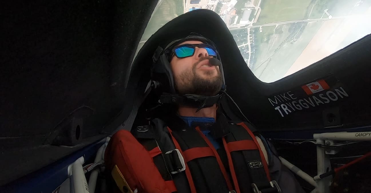 Cockpit view of pilot Mike Tryggvason (Canada) looking skyward mid-flight, with his name and a maple leaf marked on the canopy