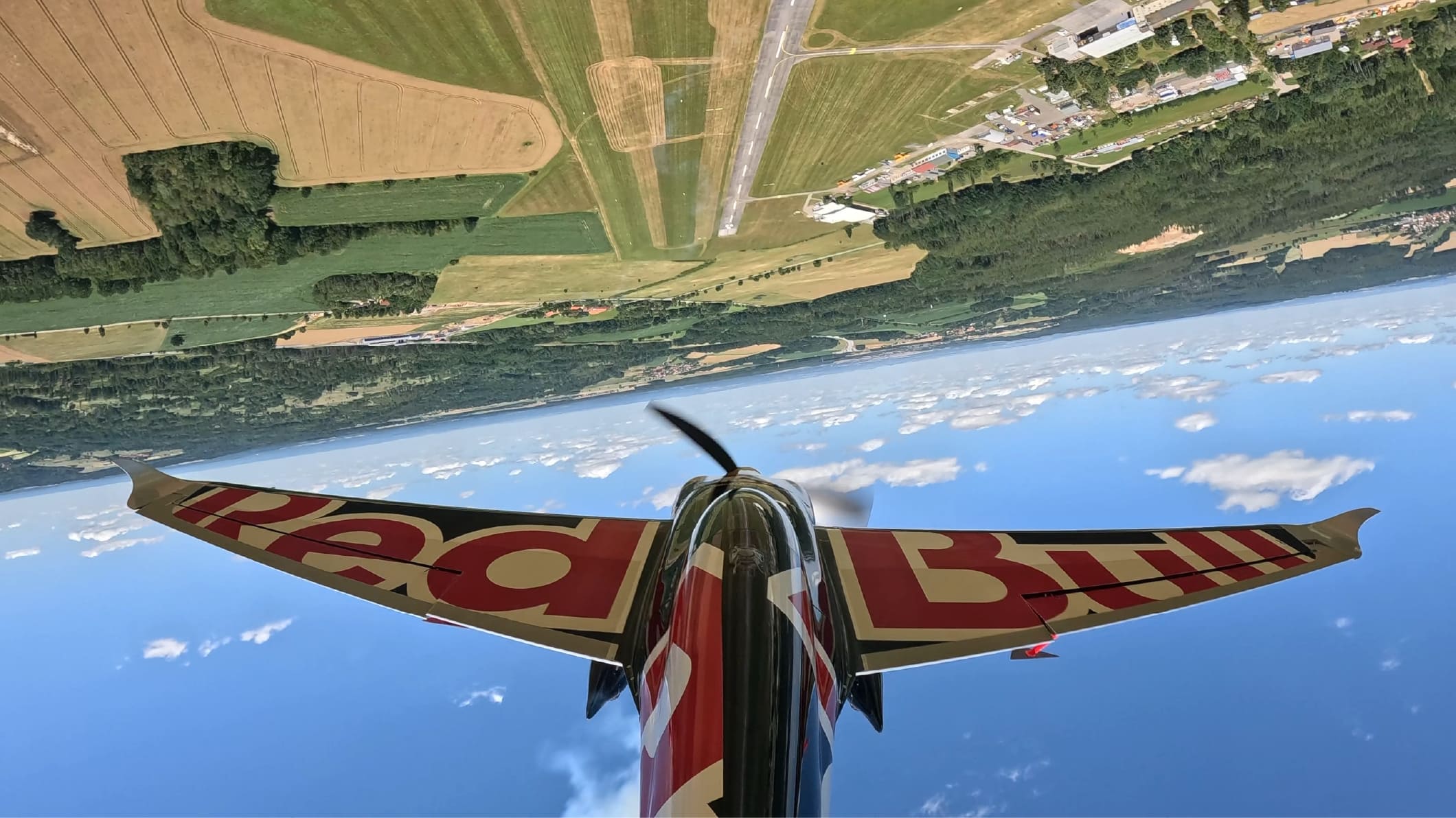 An AIR RACE X aircraft banking over the airfield during a Race 4 heat